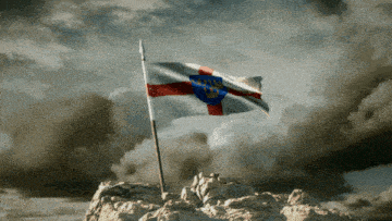 a flag with a cross on it is on top of a rocky hill