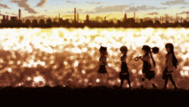 a group of girls are walking along a body of water
