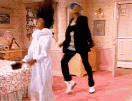 a man and woman are dancing in a bedroom .