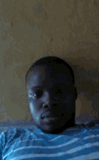 a man wearing a blue and white striped shirt is looking at the camera