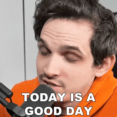 a man speaking into a microphone with the words today is a good day behind him