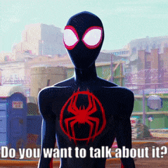 a man in a black suit with a red spider on his chest says " do you want to talk about it "