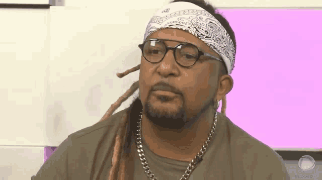 a man with glasses and a bandana on his head