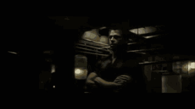 a man is standing in a dark room with the words bienvenue au fight club below him