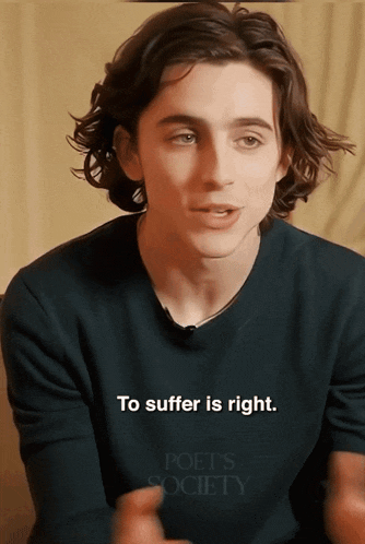 a young man wearing a shirt that says poet 's society on it