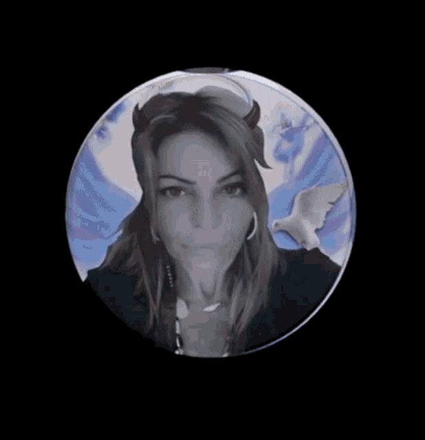 a woman with horns and wings is in a circle on a black background