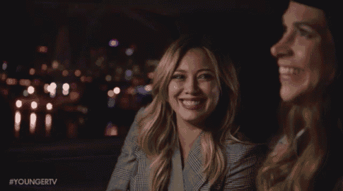 two women are sitting next to each other and smiling with the hashtag youngertv on the bottom