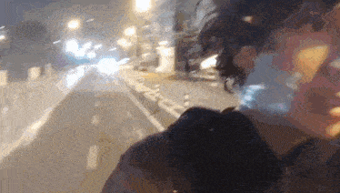 a blurry picture of a person walking down a street with a sign on the side that says ' a '