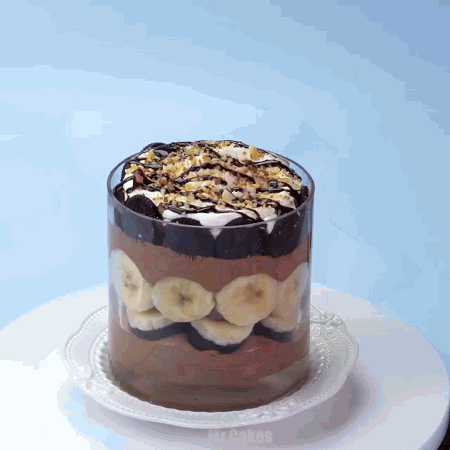 a trifle with bananas and chocolate on a white plate