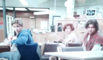 a group of people are sitting at a table in a restaurant