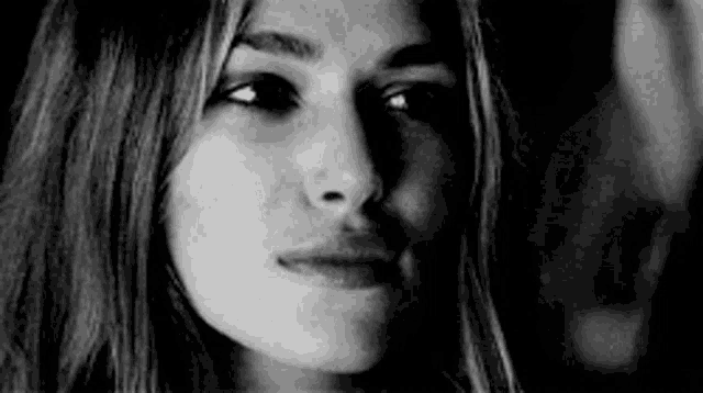 it is a black and white photo of a woman 's face .