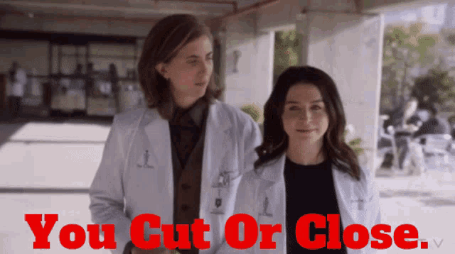 two women in lab coats are standing next to each other with the words you cut or close behind them