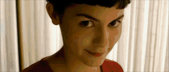a close up of a woman 's face with a red shirt on .
