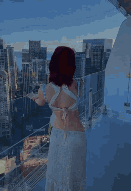 a woman with red hair has a tattoo on her arm that says ' aloha '