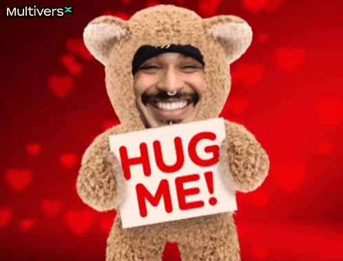 a teddy bear with a man 's face on it is holding a sign that says hug me