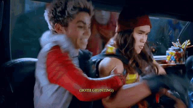 a man and a woman are sitting in the back seat of a car and the man is holding the woman .