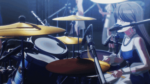 a girl is playing drums in front of a microphone