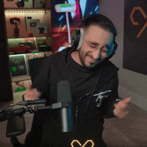 a man wearing headphones is dancing in front of a microphone .
