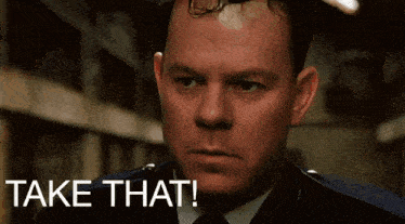 a man in a suit says take that
