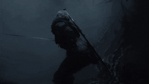a person holding a rifle in the dark