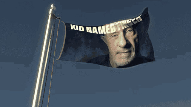 a flag with a picture of a man and the words kid named trent