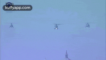 three helicopters are flying in a blue sky with the website kulfyapp.com in the upper right corner
