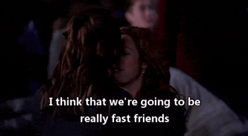 two women are hugging each other in a dark room and they are talking about being really fast friends .