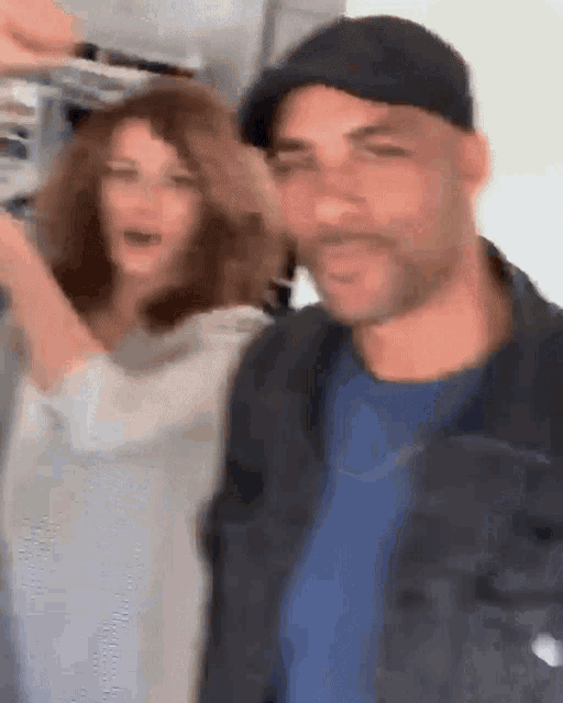 a man and a woman are posing for a photo