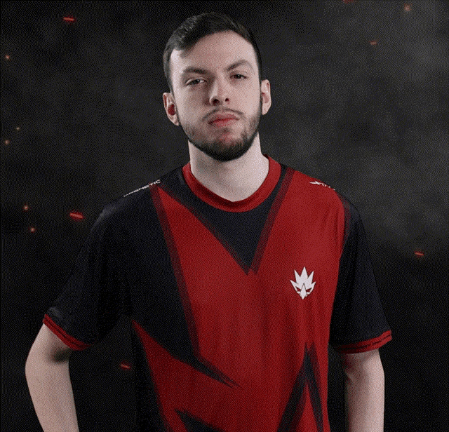 a man wearing a red and black shirt with a maple leaf on the front