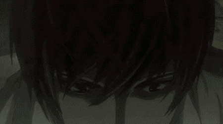 a close up of a man 's face with red eyes