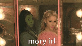 two women standing next to each other with the words mory irl on the bottom right