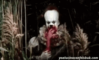 pennywise the clown from it is eating a piece of meat while standing in a field .
