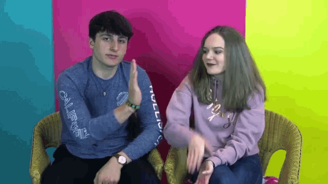 a boy and a girl are sitting next to each other and the girl is wearing a hollister sweater