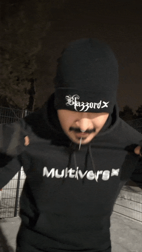 a man wearing a beanie and a hoodie that says multiverse