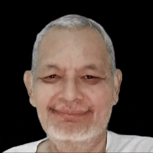 a close up of a man 's face with arabic writing on the bottom right
