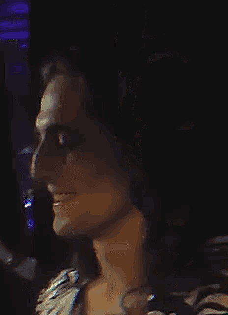 a blurry picture of a man 's face with a purple light in the background