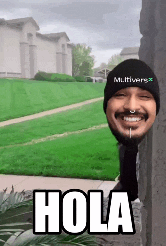 a man wearing a black multivers hat is smiling