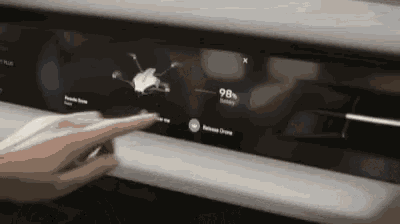 a person is pressing a button on a screen that says ' reverse drive ' on it