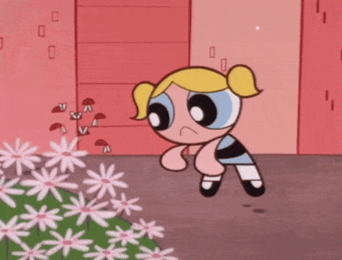 bubbles from the powerpuff girls is standing in front of a flower bed