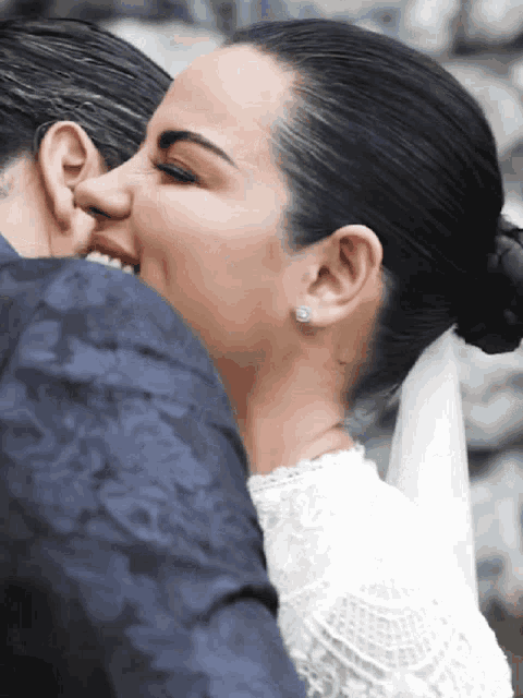 a close up of a woman 's face with a man 's ear visible