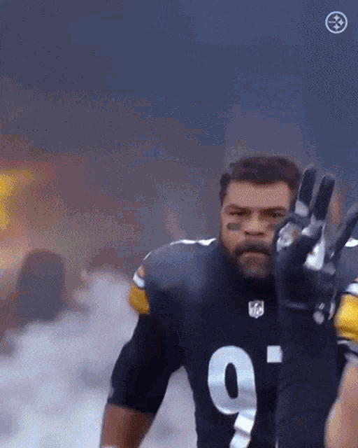 a football player with the number 9 on his jersey is waving