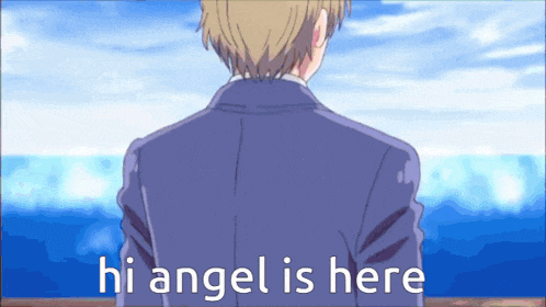 a man in a suit stands in front of the ocean with the words hi angel is here