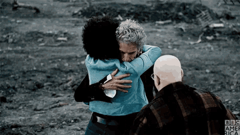a group of people hugging each other with bbc america written on the bottom right