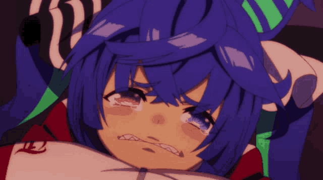 a girl with blue hair is crying and has the number 12 on her shirt