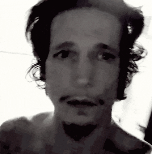 a black and white photo of a man 's face