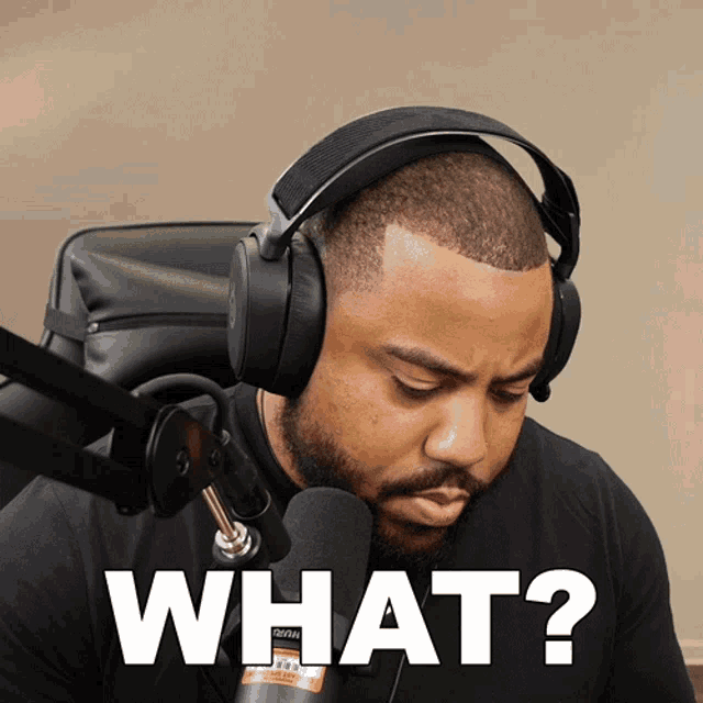 a man wearing headphones and a microphone is asking the question what