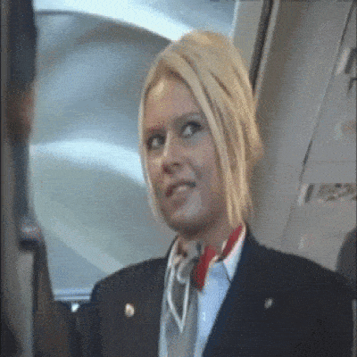 a stewardess on an airplane with the word emergency on the side