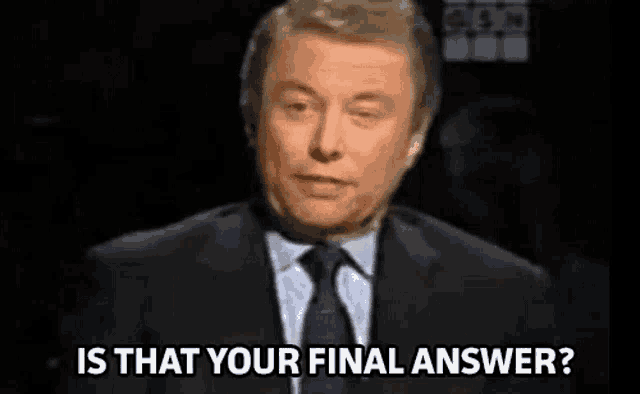 a man in a suit and tie is standing in front of a black background and asking , `` is that your final answer ? ''