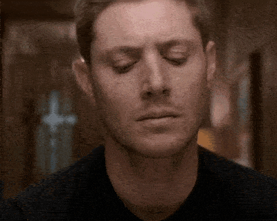 a close up of a man 's face with his eyes closed .
