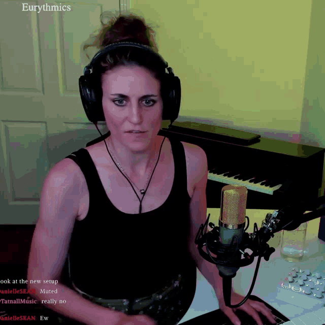a woman wearing headphones sits in front of a microphone with the words eurothmics on the top left